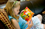 child reading dressing up box book